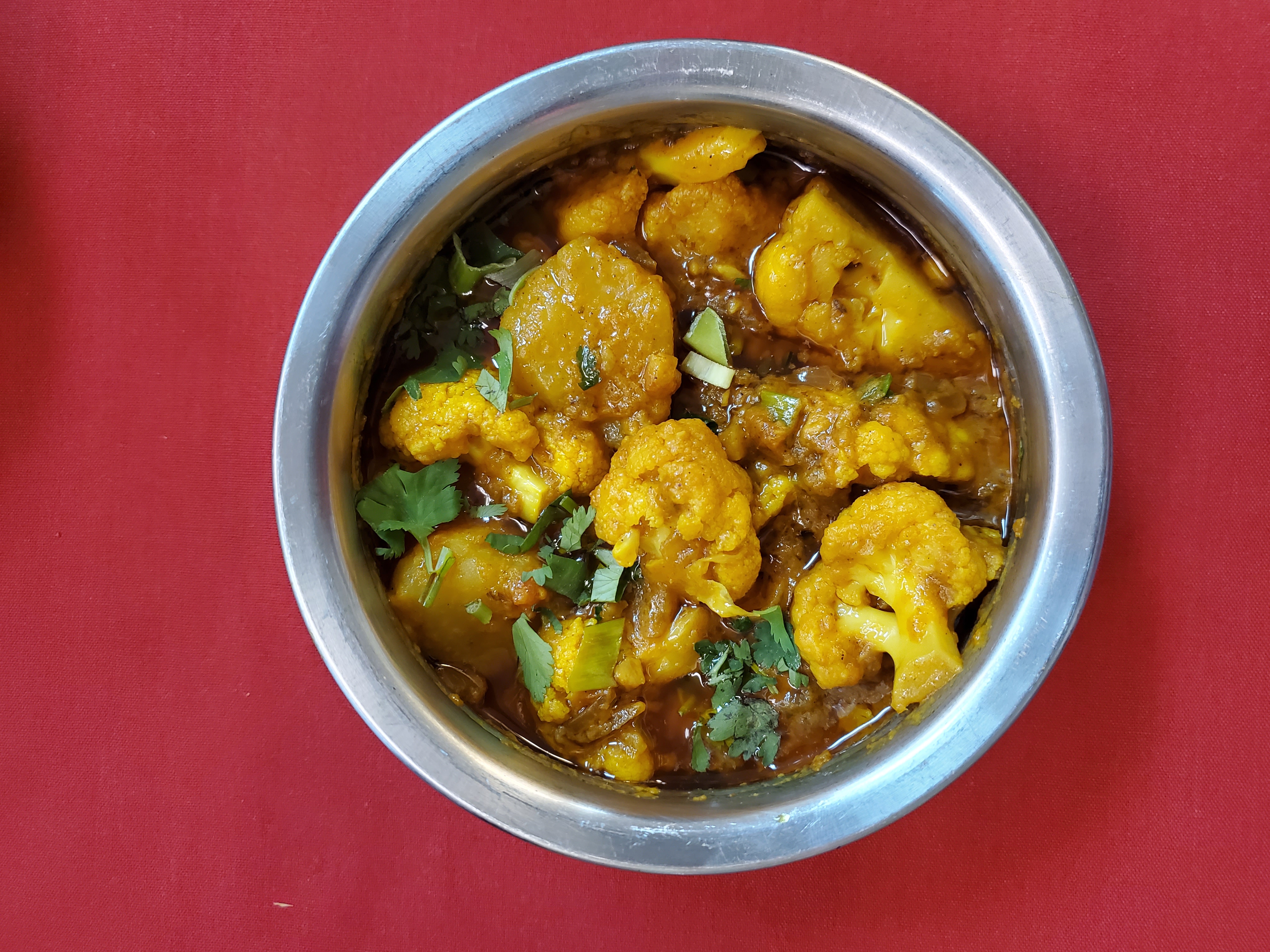 Aloo Gobi — Fresh cauliflower and potato sautéed in mild spices with tomato — at Himalayan Restaurant